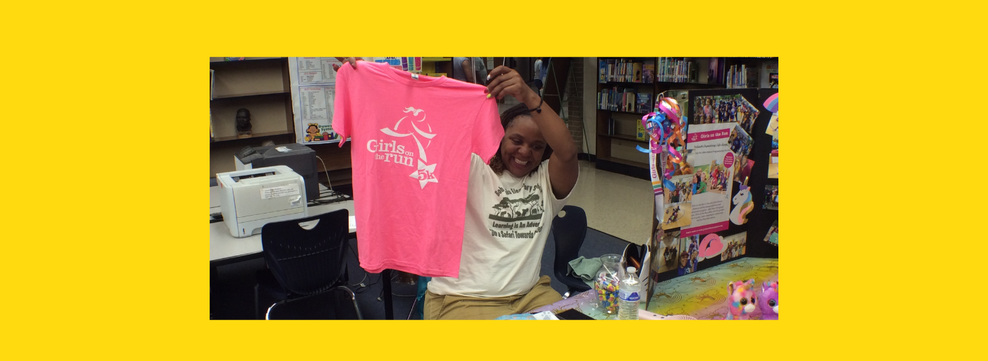 girls on the run tee shirt teacher holding
